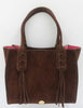 Elaine Turner Mauney Satchel Handbag in Chocolate Brown Suede with Fringe and and braided detail. Signature pink suede lining. Gray background. 