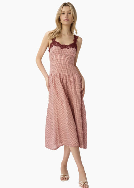 Woman wearing a berry checkered dress with lace straps on a white background. CAMI NYC Kairina Midi Dress in Berry Gingham at Edit by Elaine Turner. Full body view. 