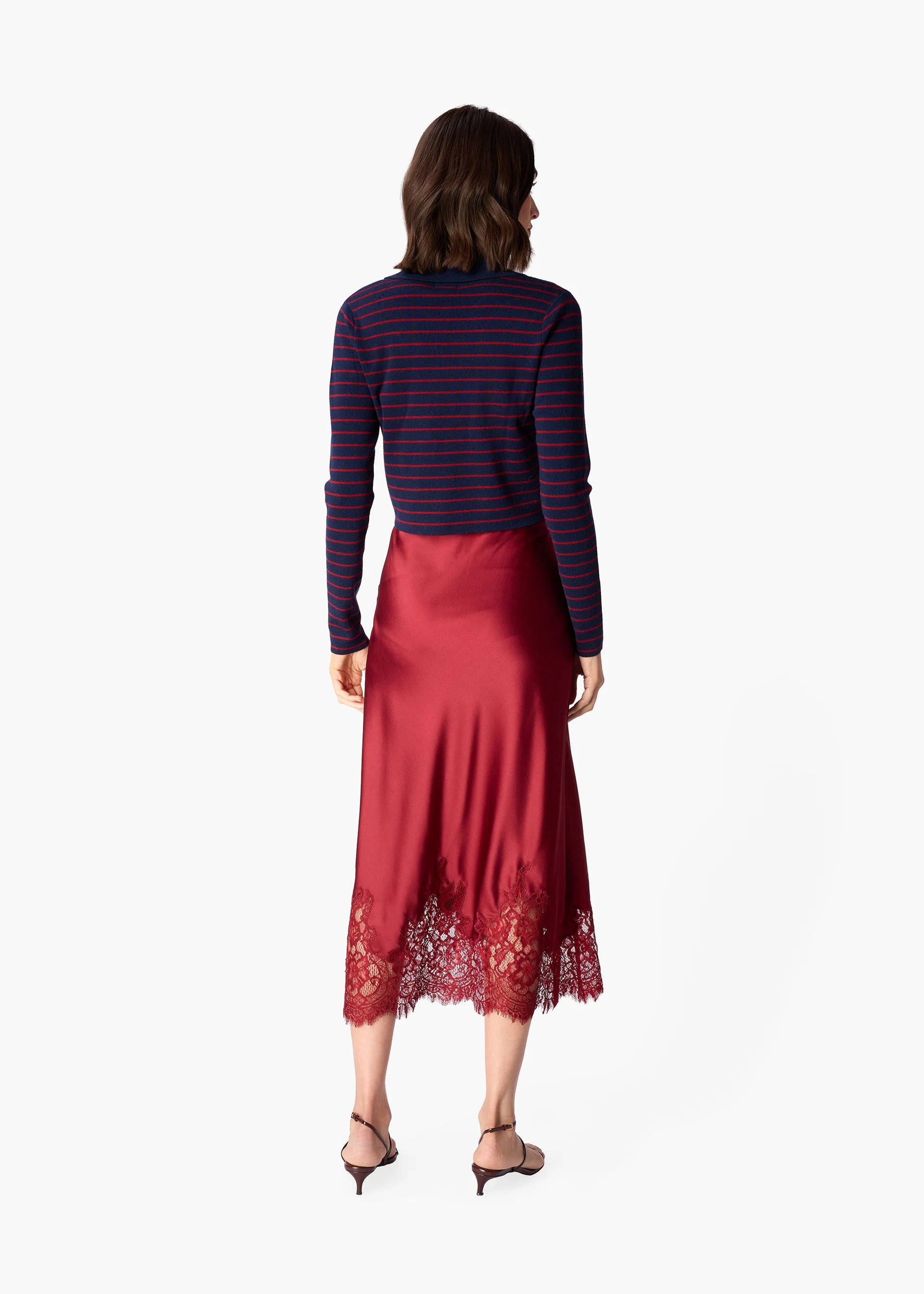 Woman wearing a deep red skirt with lace hem on a white background
CAMI NYC Vivienne Skirt compote
Available at Edit by Elaine Turner in Houston, TX.
Back model view