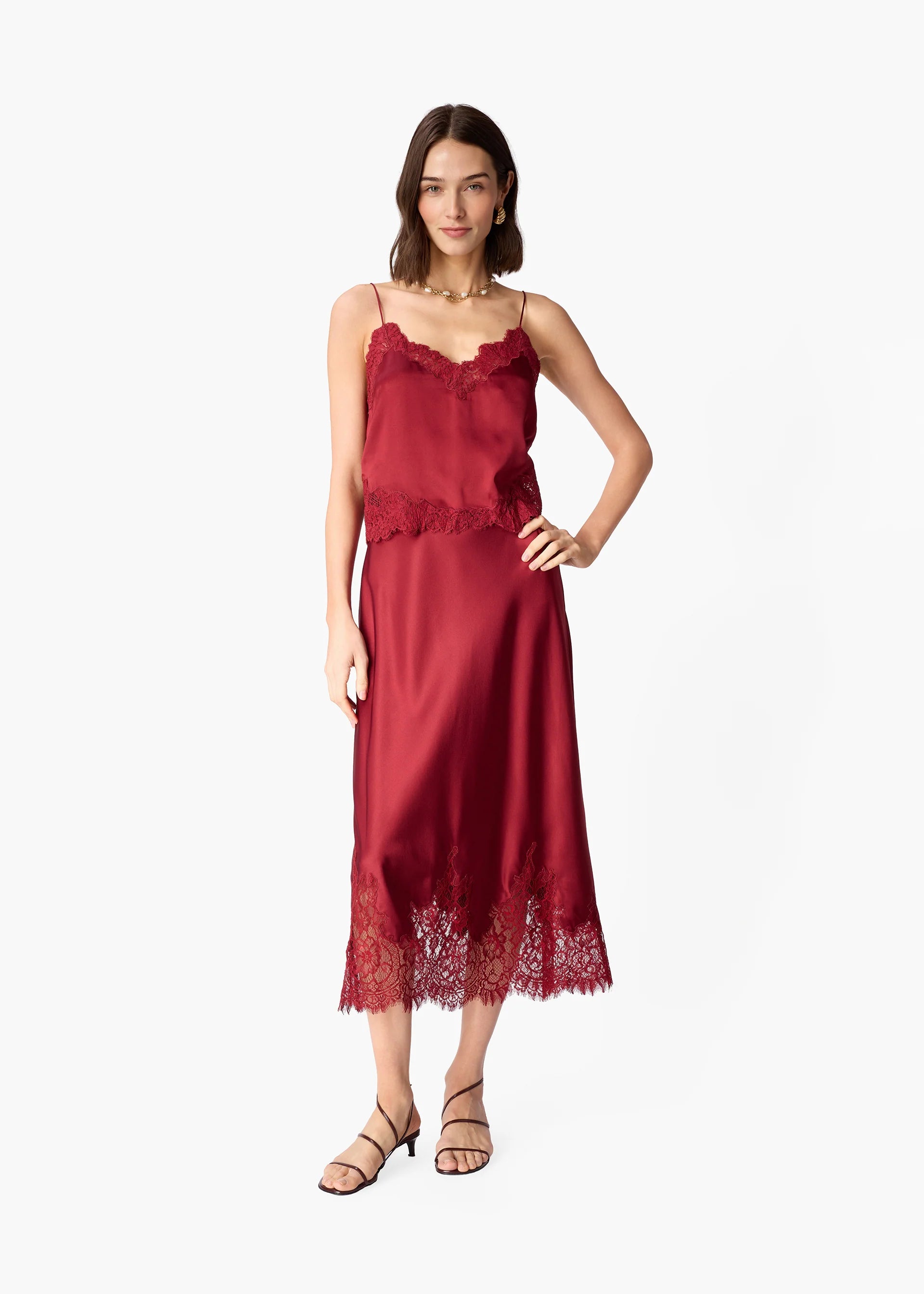 Woman wearing a deep red skirt with lace hem on a white background
CAMI NYC Vivienne Skirt compote
Available at Edit by Elaine Turner in Houston, TX.
Full model model view