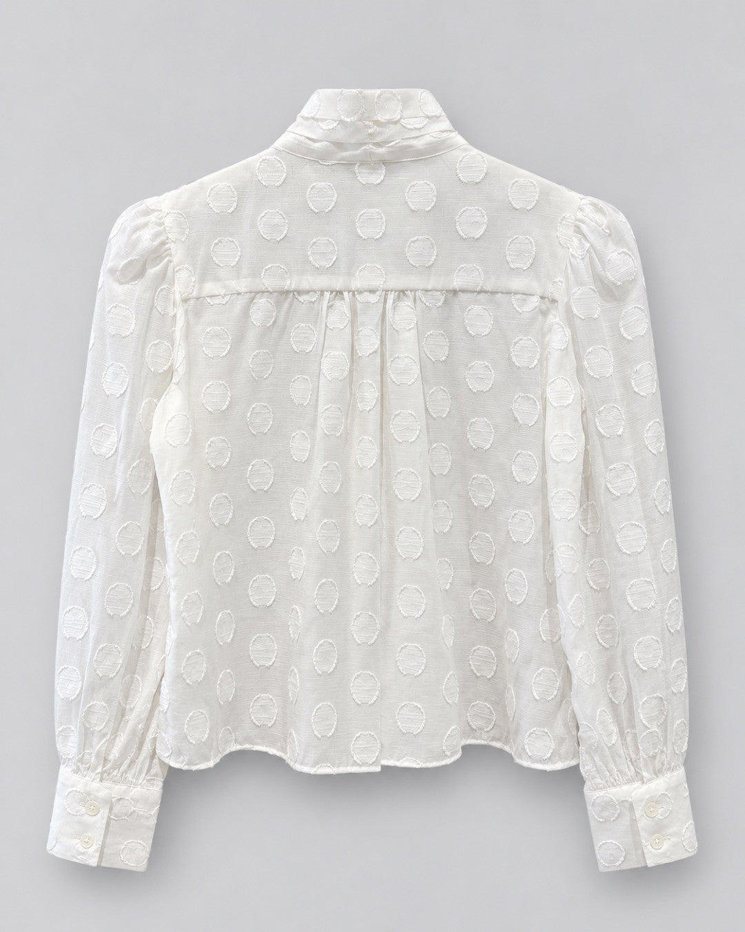 CISSA- The Bow Tie Blouse in sheer polka dot. Available at Edit by Elaine Turner in Houston, TX. Back flat lay view. 