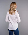 A woman with blonde hair is shown from behind wearing a white long-sleeve button-down shirt and blue jeans, standing against a solid gray studio background.

Claridge & King- The Great White Shirt No. 1 - Available at Edit by Elaine Turner in Houston, TX. Back Model View