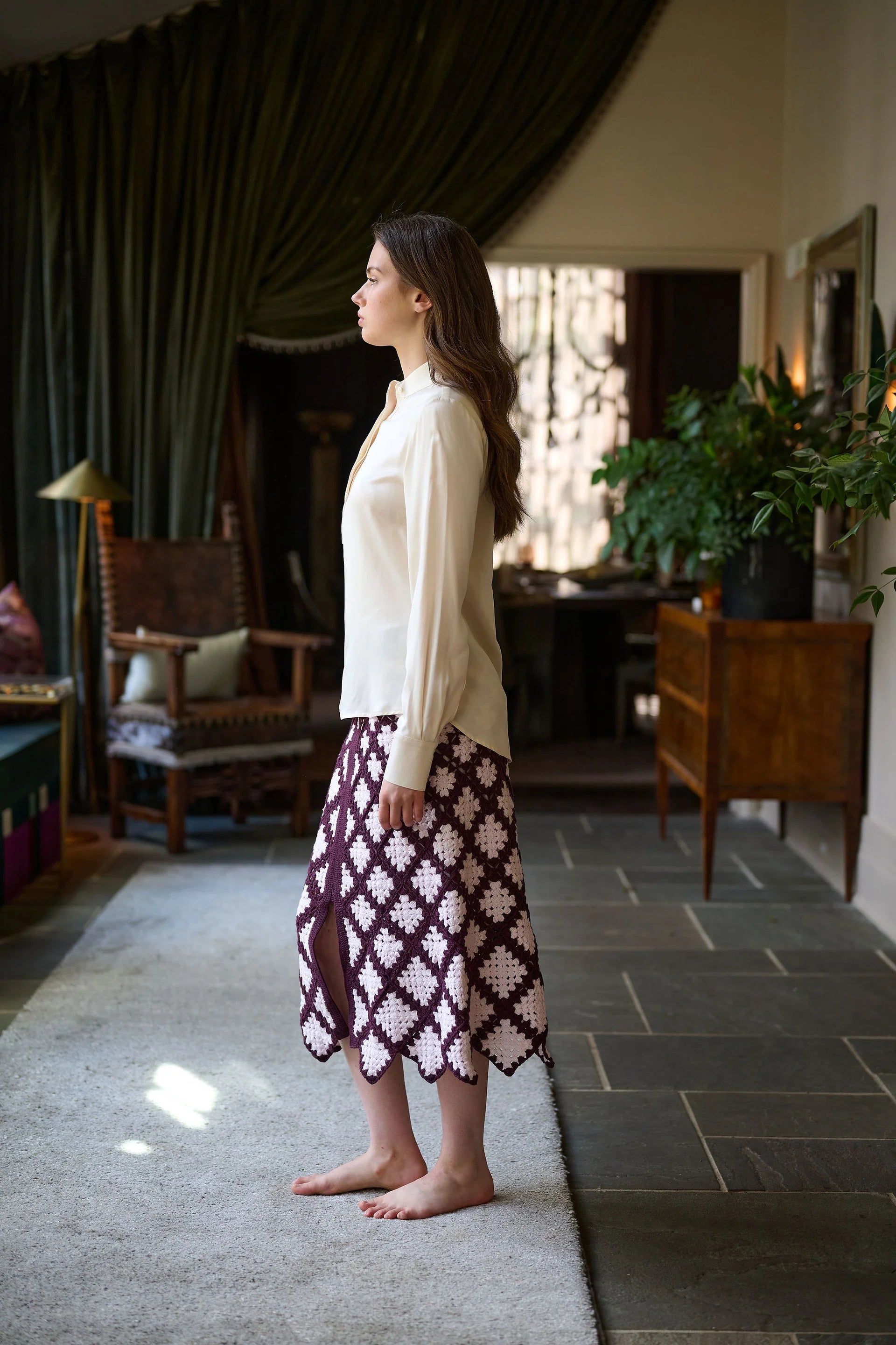 Woman standing in a sunlit room with dark curtains and wooden furniture.

Daniel Gonzalez Marina Blouse in Foam. Available at Edit by Elaine Turner in Houston, TX. Side Model View. 