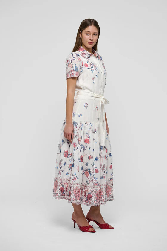Woman wearing a floral dress on a white background. Dea Kudibal Lunadea Midi Dress at edit. By Elaine Turner. Model is showing the side view. 