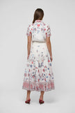 Woman wearing a floral dress on a white background. Dea Kudibal Lunadea Midi Dress at edit. By Elaine Turner. Model is showing the back view. 