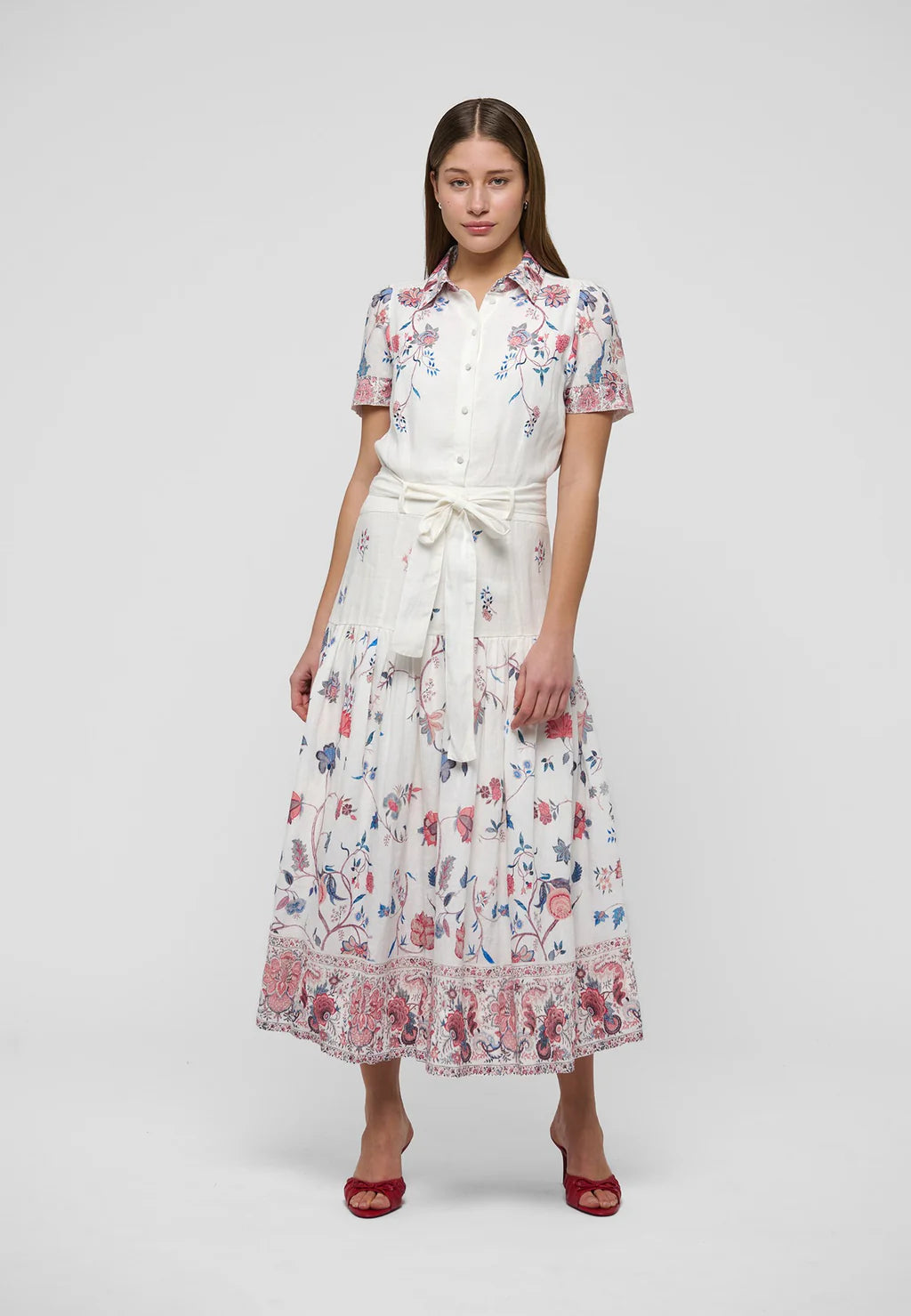 Woman wearing a floral dress on a white background. Dea Kudibal Lunadea Midi Dress at edit. By Elaine Turner. Model is showing the front view. 