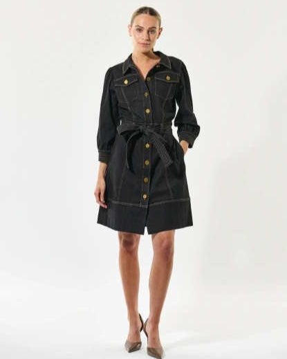Woman wearing a dark denim dress with gold buttons on a white background by Dea Kudibal