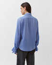 Diega Capa Blouse in Bleu. Available at Edit by Elaine Turner in Houston, TX. Full model back view. 