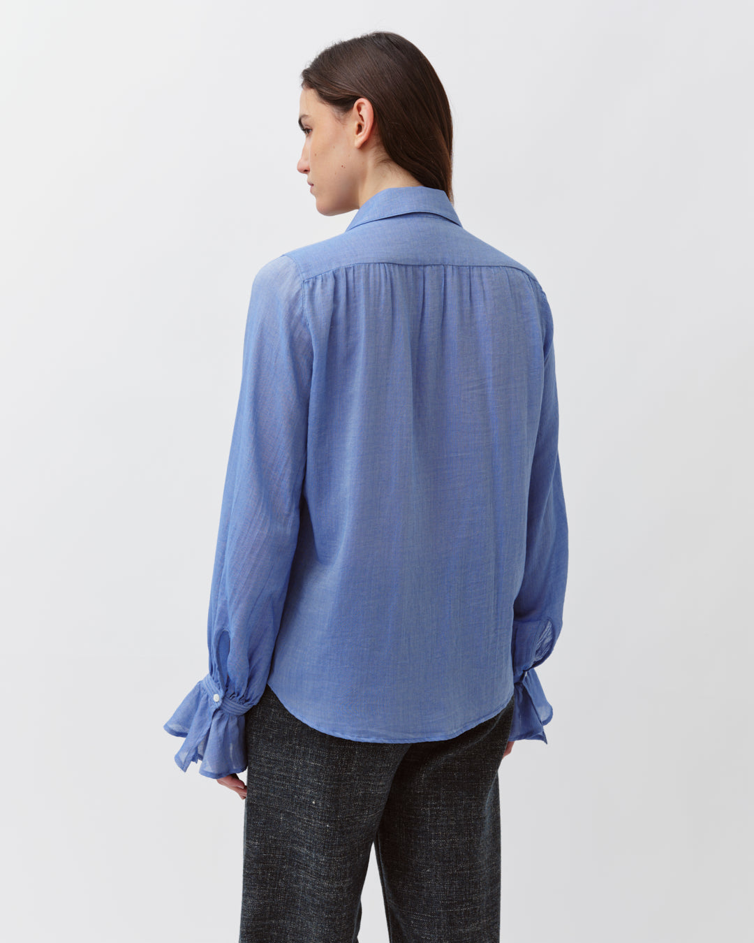 Diega Capa Blouse in Bleu. Available at Edit by Elaine Turner in Houston, TX. Full model back view. 