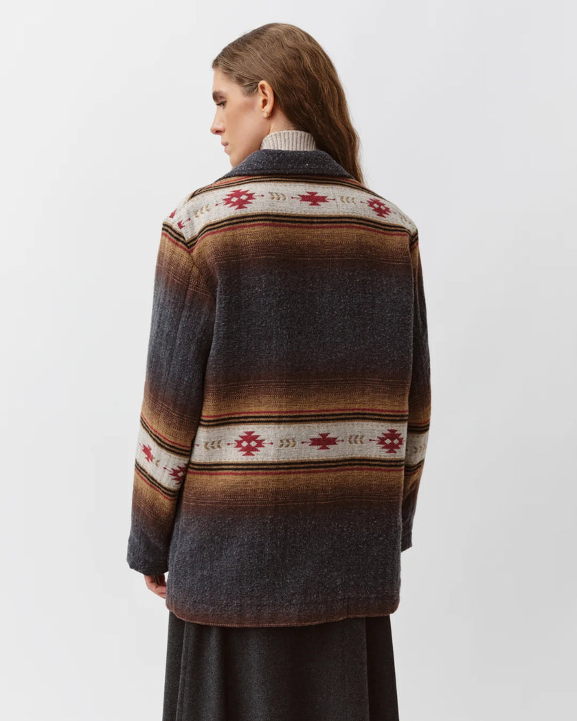 A woman shown from the back wearing a long-sleeve knit cardigan with horizontal stripes in dark gray, brown, and beige, featuring red geometric patterns.

Diega Virato Jacket in anthracite. Available at Edit by Elaine Turner in Houston, TX. Full back model view. 