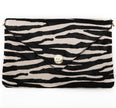 A black and white zebra-patterned clutch Elaine Turner Handbag with signature metallic ET logo plate on the front.