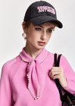 Essentiel Antwerp-Kasa Pullover sweater - millenial pink. Available at edit by Elaine Turner in Houston, TX. Model close up view.
