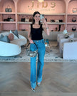 Edward Achour Black tank top with detachable bow, worn with Re/Done denim jeans and Elaine Turner Zebra haircalf Sawyer bag.