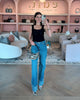 Edward Achour Black tank top with detachable bow, worn with Re/Done denim jeans and Elaine Turner Zebra haircalf Sawyer bag.