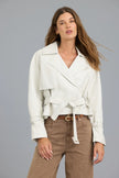 A woman modeling a white wrap-style jacket with a tie belt, paired with brown pants, against a solid gray studio background.

JAKETT- Naomi Vintage Leather Jacket in Coconut. Available at Edit by Elaine Turner in Houston, TX. Front model view. 