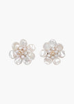 A pair of flower-shaped stud earrings made from irregular white baroque pearls, shown on a plain light gray background.

Jennifer Behr- Margo Earrings - Pearl. Available at Edit by Elaine Turner in Houston, TX. 