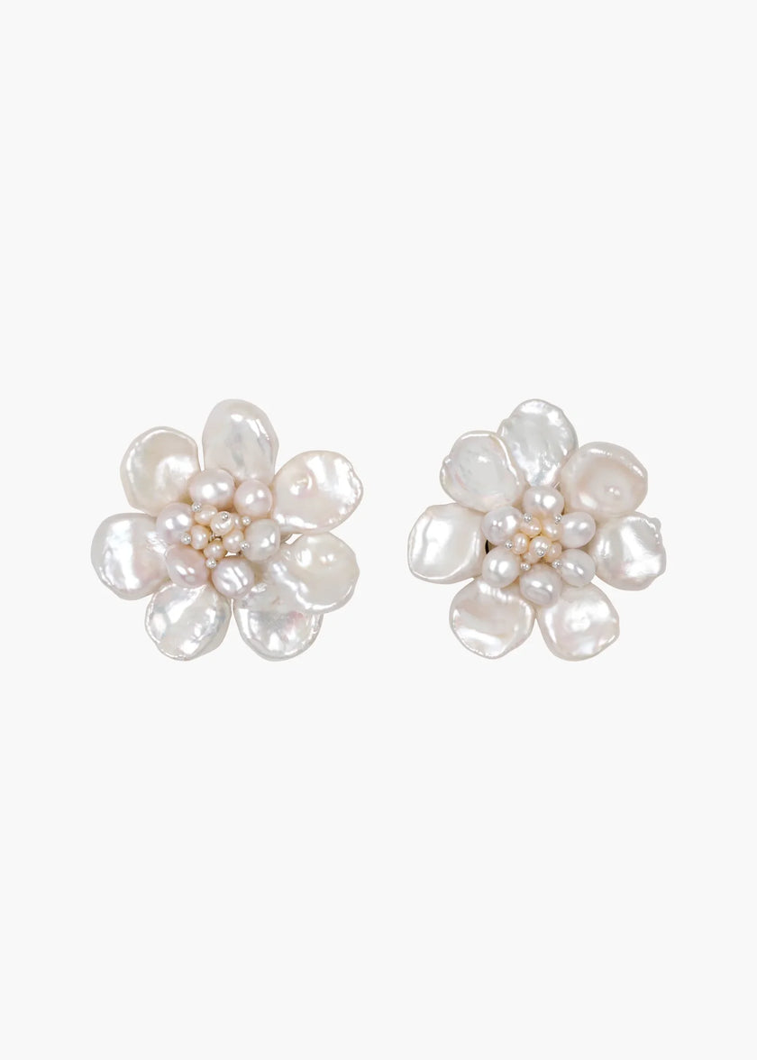 A pair of flower-shaped stud earrings made from irregular white baroque pearls, shown on a plain light gray background.

Jennifer Behr- Margo Earrings - Pearl. Available at Edit by Elaine Turner in Houston, TX. 