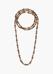 A multi-strand beaded necklace made of brown and black tiger's eye beads, arranged in a loop on a plain light gray background.

Jennifer Behr- Veda Necklace - Tigers Eye. Available at Edit by Elaine Turner in Houston, TX. 