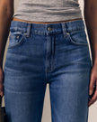 Close-up of a person wearing medium blue denim jeans with a gray ribbed top, showing the front waistband, button, belt loops, and front pockets.

Le Jean Mid 90's Straight in North Star. Available at Edit by Elaine Turner in Houston, TX. Full model close-up view. 
