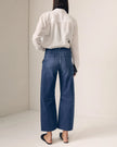 Person wearing a white shirt and blue jeans against a plain background. 

Le Jean Utility Soft Barrel in London Calling. Available at Edit by Elaine Turner in Houston, TX. Full model back view. 