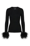 A black ribbed long-sleeve top with dramatic feathered cuffs, shown on a plain white background. 

Le Superbe- Extra Crew Neck Sweater in black. Available at Edit by Elaine Turner in Houston, TX. 