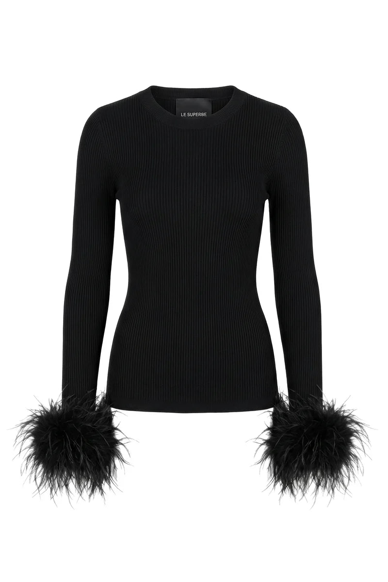 A black ribbed long-sleeve top with dramatic feathered cuffs, shown on a plain white background. 

Le Superbe- Extra Crew Neck Sweater in black. Available at Edit by Elaine Turner in Houston, TX. 
