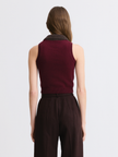 A woman shown from the back wearing a sleeveless burgundy knit top with a dark ribbed collar and dark brown wide-leg trousers, against a light gray studio background.

Matthew Bruch- Combo Collar Cropped Tank Top - Merlot Knit. Available at Edit by Elaine Turner in Houston, TX. Back Model View. 