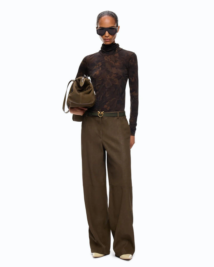 A model stands against a plain white background wearing a dark brown patterned turtleneck, wide-leg brown trousers, a dark belt with a gold buckle, sunglasses, and holding a brown bucket bag.

PINKO- Turtleneck Sweater with Floral Camouflage Print in Green & Black Multicolor. Available at Edit by Elaine Turner in Houston, TX. Full front model view. 