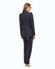 A woman shown from the back wearing a deep navy blue tailored blazer and matching trousers, paired with beige heels and black sunglasses, against a plain white background.  

Pinko- New Amalfi Giacca Lana Deep Navy Blue Double Breasted Jacket. Available at Edit by Elaine Turner in Houston, TX. Model Full Back View. 