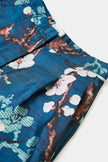 Blue fabric with floral pattern on a white background. 

Psophia Palazzo Trousers in Almond Blossom. Available at Edit by Elaine Turner in Houston, TX. Close-Up View. 