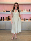 Twinset Milano Khaki Midi Dress with low v-neck neckline and criss cross detail to waist line. Midi skirt has darted pleating from waist and two buttons at center waistline. Model, Elaine Turner, is wearing Black Suede Studio mules in nude ostrich and Chan Luu Necklace in Turquoise and Tiger Eye. Photo is taken inside edit. BY ELAINE TURNER boutique in Houston, Tx.
