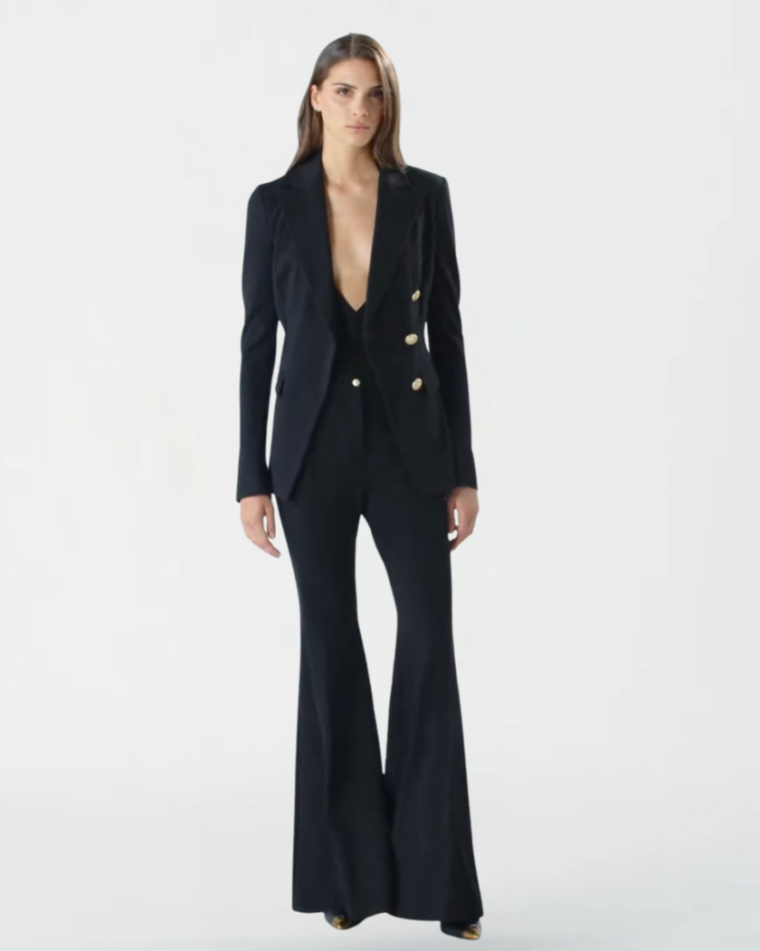 Woman wearing a black suit with a plunging neckline on a white background by PINKO